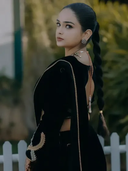 A view of the back of the black velvet outfit. The simple, clean lines and the beautiful drape of the fabric create a stunning look.