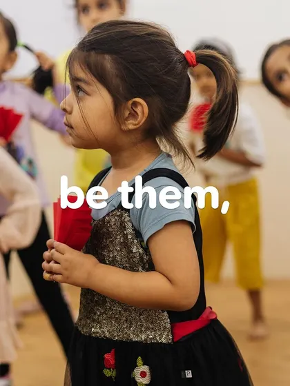 "May we be them." A young girl stands confidently, ready to take on the world. We are committed to nurturing this spirit in all our students.