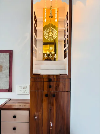 This shot shows the mandir as a complete piece of furniture, fitting elegantly into the corner of a room.