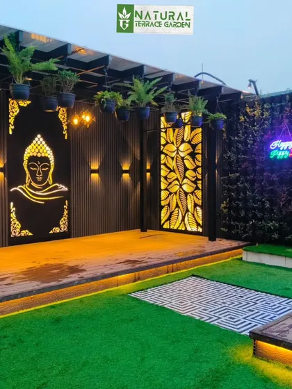 The completed pergola area in Uttam Nagar, featuring backlit art panels, hanging plants, and a vertical garden.