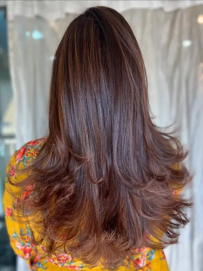 The full look of the seasonal caramel hair, styled with soft layers that create movement and volume.