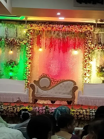 A beautifully decorated sangeet stage with floral arrangements and elegant lighting, all set for the performances.