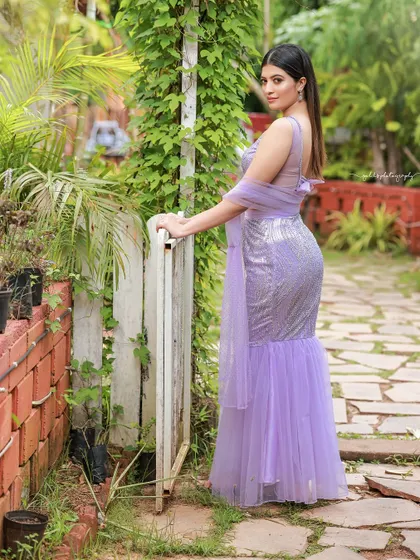 A designer shoot for a modern lavender lehenga. The images were taken in a lush garden, with the purple flowers complementing the color of the outfit, creating a soft and romantic fashion story.