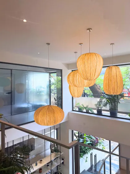 The view from the mezzanine at our Indiranagar cafe, highlighting the double-height ceiling, natural light, and our signature woven pendant lights.