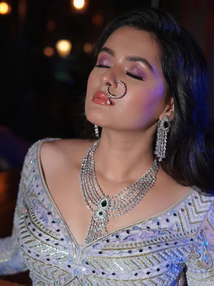 A close-up on the dramatic eye makeup and glossy lip, a perfect combination for a reception or cocktail party.