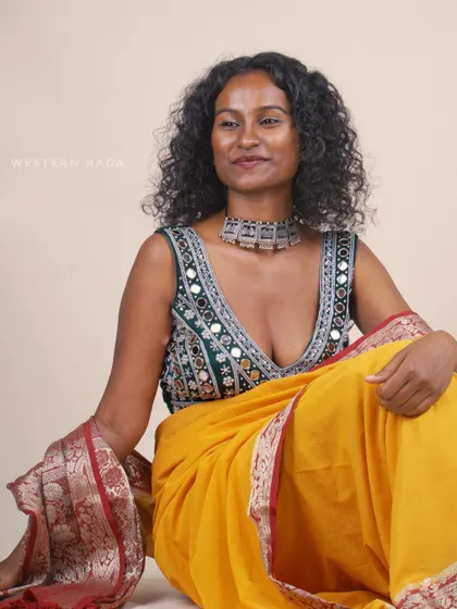 This portrait showcases the pairing of the Shisha blouse and yellow saree with a calm and graceful expression. It demonstrates how the same outfit can be styled to convey different moods, from joyful to serene.