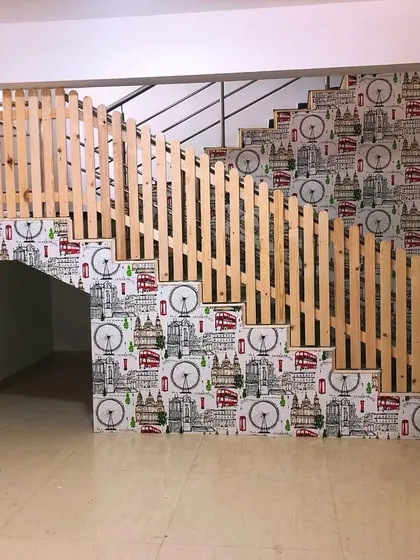 Another angle of the staircase project, showing how the wallpaper complements the wooden railing.