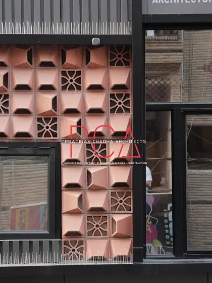 A close-up view of the terracotta jaali panels on the Chadha Properties facade, showing the craftsmanship and unique texture they bring to the building.