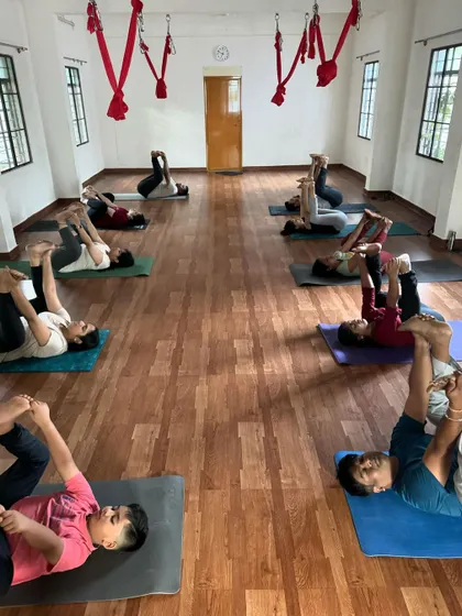 Students in our 6 am Yin Yoga class practicing Ananda Balasana (Happy Baby Pose). This pose is wonderful for releasing tension in the hips and lower back.
