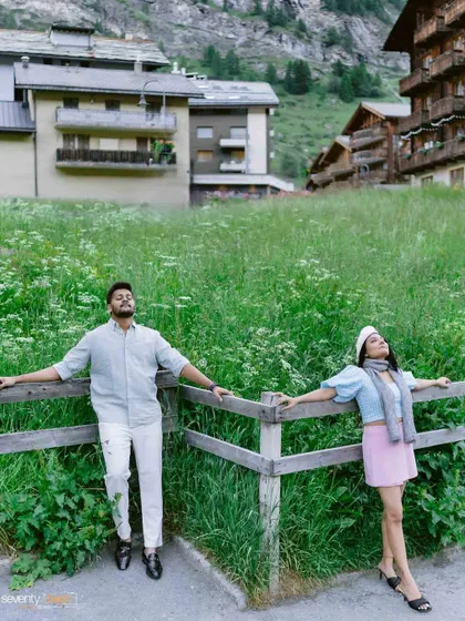 Leaning against a rustic fence in a field of wildflowers, they soak in the alpine air. A relaxed, candid portrait that captures the peaceful, romantic vibe of Zermatt.