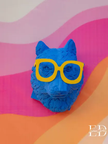 A quirky blue wolf head with bright yellow glasses adds a touch of humor and personality to the decor. These small, unexpected details are what make an event truly unique.