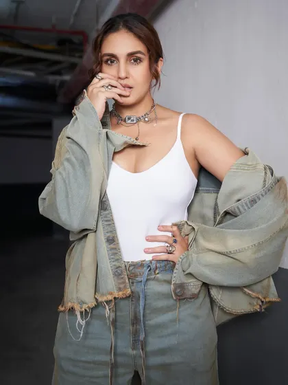 A closer look at the grunge details. The layered silver chokers and rings add that essential raw edge to Huma's denim look.