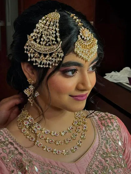Another angle of the side profile, giving a clear view of the earrings and the hairstyle.