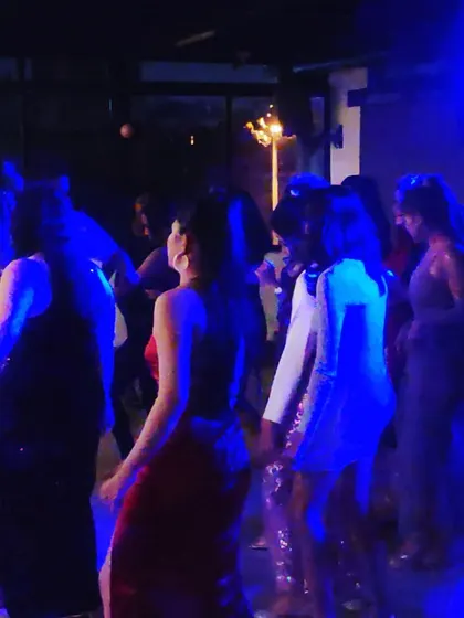The energy picking up as more people join the dance floor.
