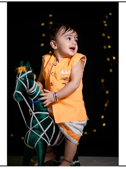 A classic studio portrait of a toddler enjoying a prop horse against a dark backdrop with soft lighting. My studio sessions are perfect for creating timeless and focused child portraits.