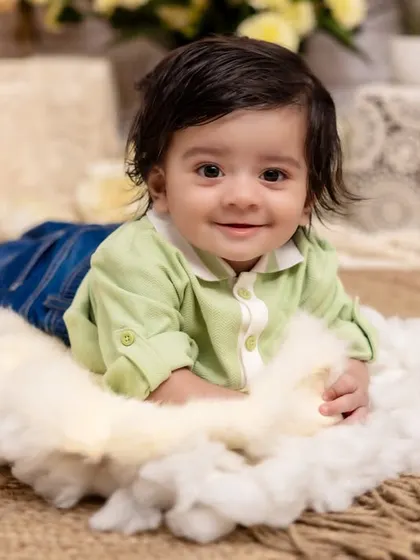 A pure and simple smile that lights up the room. This tummy time shot on a bed of soft clouds captures the innocent joy of a baby discovering the world around them.