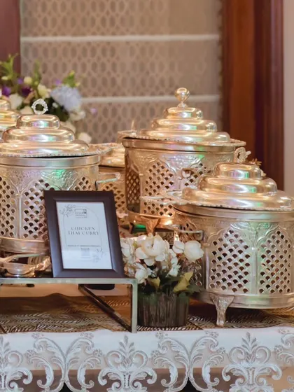 A wider angle of the silver-plated chafing dishes, showcasing a cohesive and regal look for a special event. The setup is both functional and a beautiful decorative element.