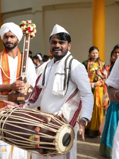 Devotees play traditional instruments like the dholak and veena during the Ashadhi Ekadashi procession. The entire ashram resonates with the sounds of devotion.