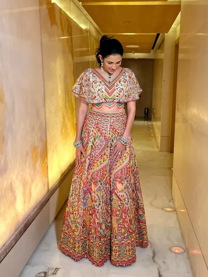 Another stunning multi-colored lehenga from Abu Jani Sandeep Khosla. The cape-like blouse sleeves give this traditional outfit a very contemporary and dramatic flair.