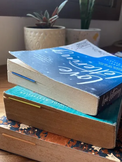 A stack of books with my thin magnetic bookmarks peeking out.
