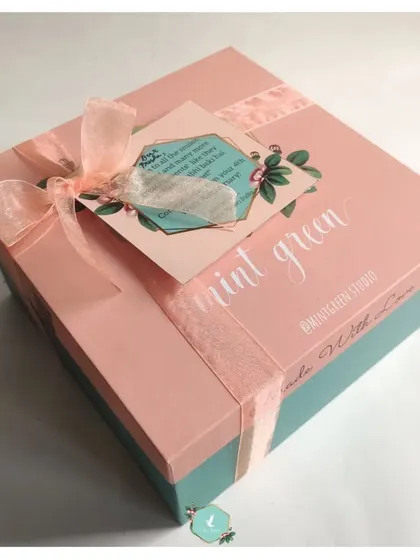 The final presentation of a work anniversary gift. This beautifully wrapped box with a custom note shows how I combine professional branding with a personal touch to make employees feel celebrated.