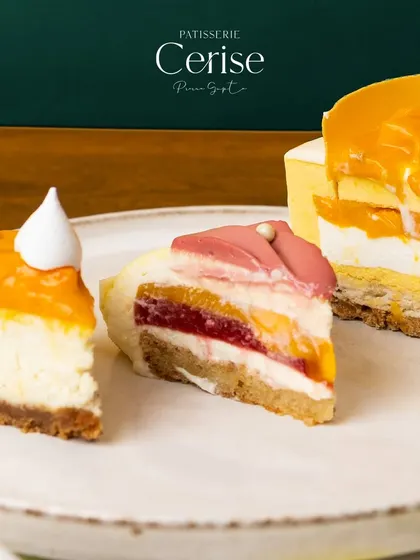 I am here to put a smile on your face with every scrumptious bite. This image displays slices of three different entremets, each a daily dose of happiness.