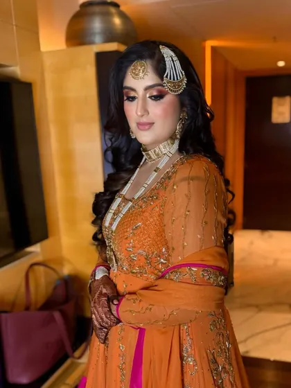 A close-up of the bride's regal look, her hair styled in classic, glamorous waves.