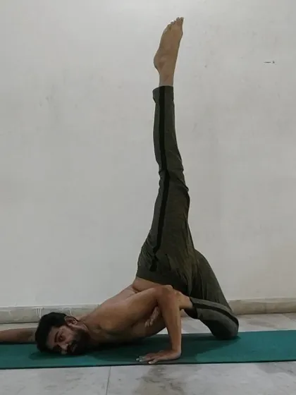 An advanced side-lying leg-lift pose that deeply stretches the hamstrings and hips while challenging your balance and core stability.