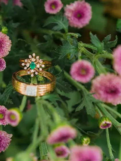 A creative shot of the wedding rings nestled among fresh flowers. I ensure that even the smallest details, like your precious rings, are photographed beautifully.