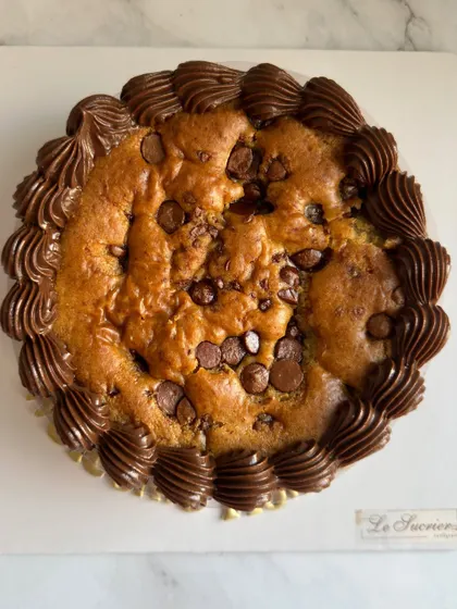 My Vanilla Choco-Chip Tea Cake is a timeless classic. It's a simple, moist vanilla cake studded with chocolate chips and finished with a border of rich chocolate frosting.