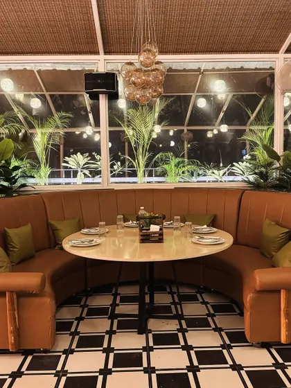 This custom-designed U-shaped booth at Tipsy Town is perfect for larger groups. The combination of the plush leather, classic checkered floor, and modern glass ball chandelier showcases my approach to mixing textures and styles for a unique furniture design.