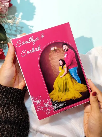 Holding the finished A5 maternity photo album, a perfect keepsake for expecting parents.