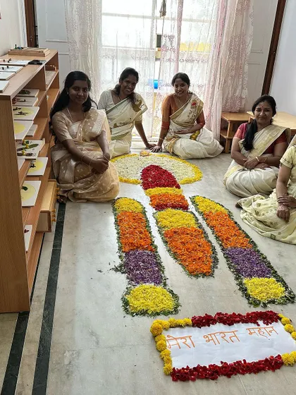Our dedicated teachers, dressed in traditional sarees, celebrating the spirit of Onam with our unique floral creation.