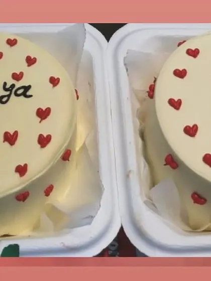 A pair of personalized bento cakes for a 20th birthday, decorated with a simple and sweet red heart pattern.