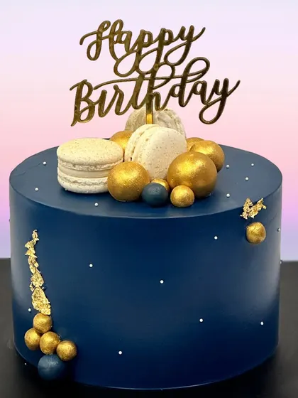 This navy blue birthday cake is the definition of chic. Topped with macarons and accented with gold leaf, it’s a sophisticated choice for an adult birthday celebration.