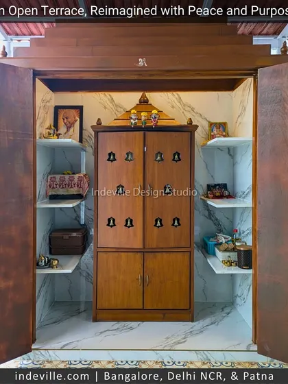 Inside the terrace temple, I designed practical and elegant storage. The marble-lined interior includes a wooden pooja unit and shelving, ensuring the sacred space is as functional as it is beautiful.