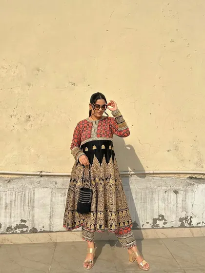 Another stunning ethnic piece, this Anarkali features a beautiful blend of red, black, and gold block prints. The silhouette is grand and perfect for a wedding.