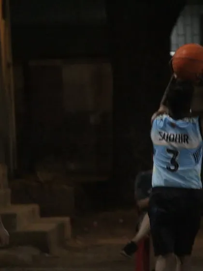 A player takes a shot under the watchful eye of a defender. Every point is hard-earned in these competitive games.