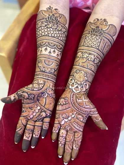 A full view of the engagement mehendi for the same client, showing the intricate patterns on both arms.