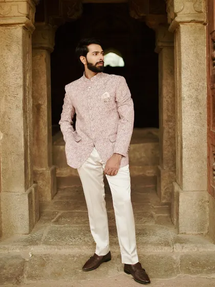 Stand out with quiet confidence in our Jodhpuri suit. The unique printed jacket paired with classic white trousers creates a look that is both elegant and effortlessly cool, ideal for a summer wedding or a daytime formal event.