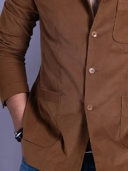 A front view of the brown corduroy jacket. This piece is perfect for adding a touch of texture and warmth to a casual look.