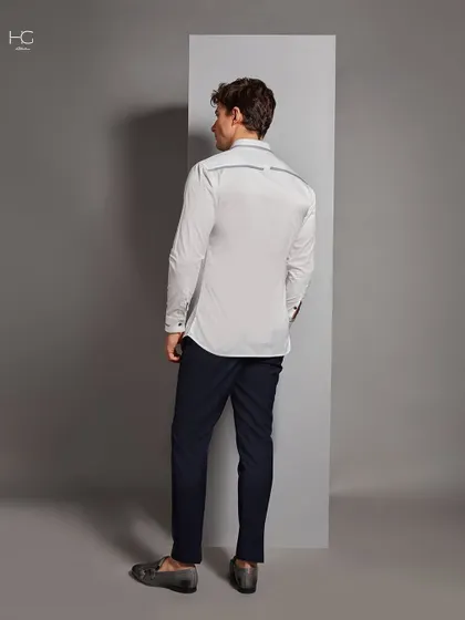 The back view of the white shirt with grey trim detailing, showing that I consider every angle to ensure a polished and complete look.