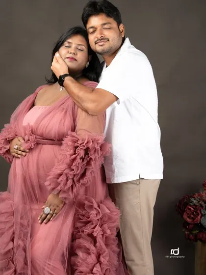 A moment of pure bliss. The genuine emotion in this pose, with eyes closed and a gentle caress, makes for a truly heartfelt maternity photograph.