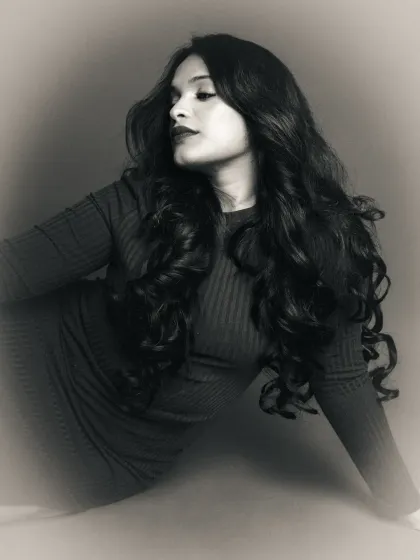A moody black and white edit of a profile portrait. The soft focus and grain create an atmospheric and introspective feel, transforming the original color shot.