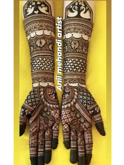 A classic full-hand mehendi with dense, intricate patterns. The design includes swans at the top and a mix of geometric and jaal work.