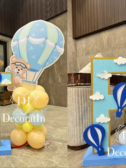 A close-up of the custom initial props, 'T' for Tanmay and 'P' for Pranay, decorated in the party's theme.