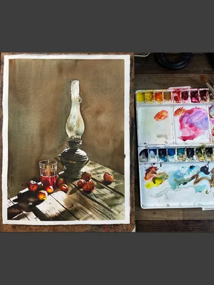 The lantern still life shown on my easel, with my palette next to it. This gives a glimpse into my process and the colors used to create the warm, rustic feel.
