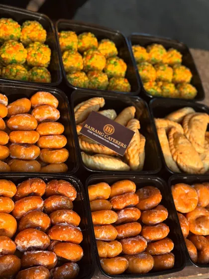 All our festival orders are packed hygienically in convenient trays. This image shows a bulk order of our Holi sweets, showcasing the care I take in preparing and delivering your food.