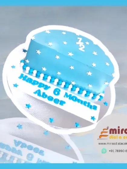 A sweet and simple half-cake for a 6-month celebration. This blue cake is decorated with white stars, celebrating "Happy 6 Months Abeer" in a charming way.
