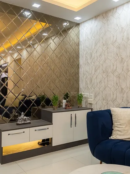 This foyer unit features a shoe cabinet with a seating bench and a stunning beveled mirror wall that adds glamour and makes the entrance feel spacious.